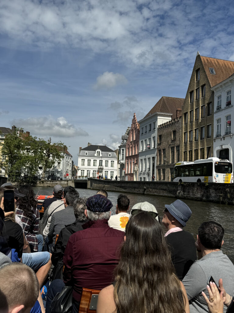 a group of people sitting on a boat in a city