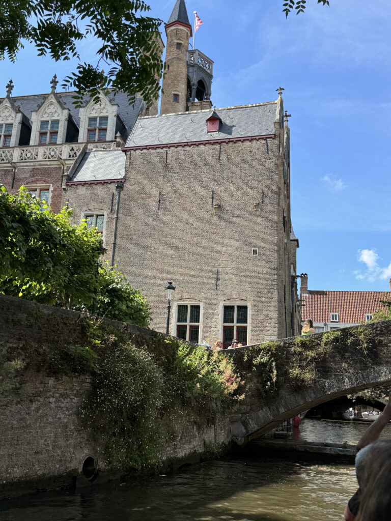 a stone building with a bridge and a tower