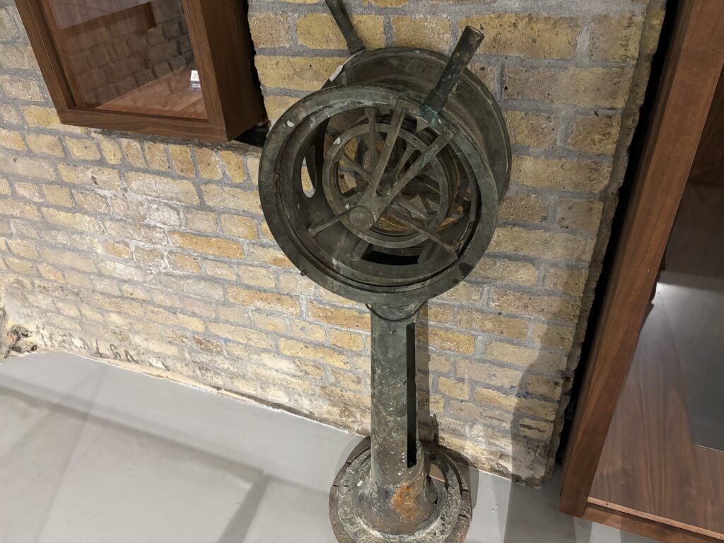 a metal object on a brick wall
