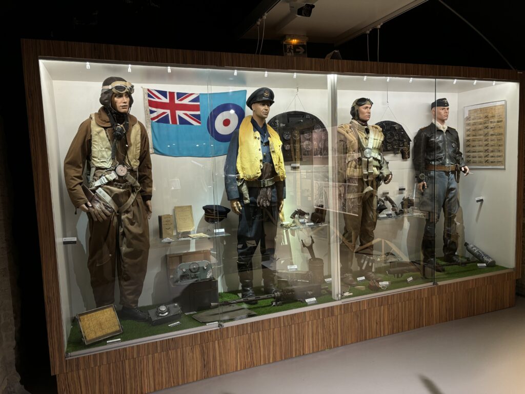 a display case with mannequins in uniform