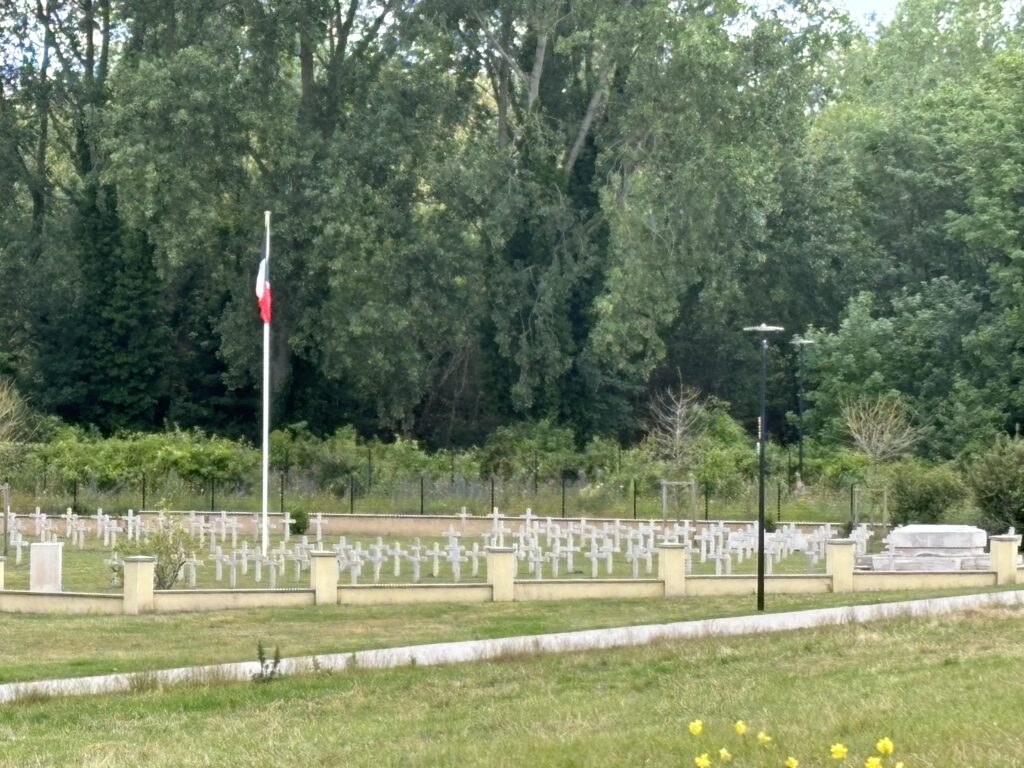 a cemetery with a flag and trees