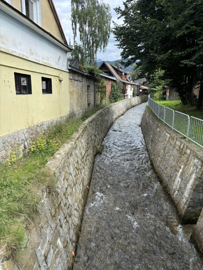 a water flowing through a stone wall