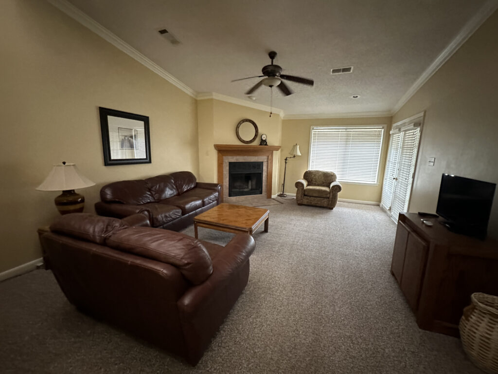 a living room with a fireplace and couches
