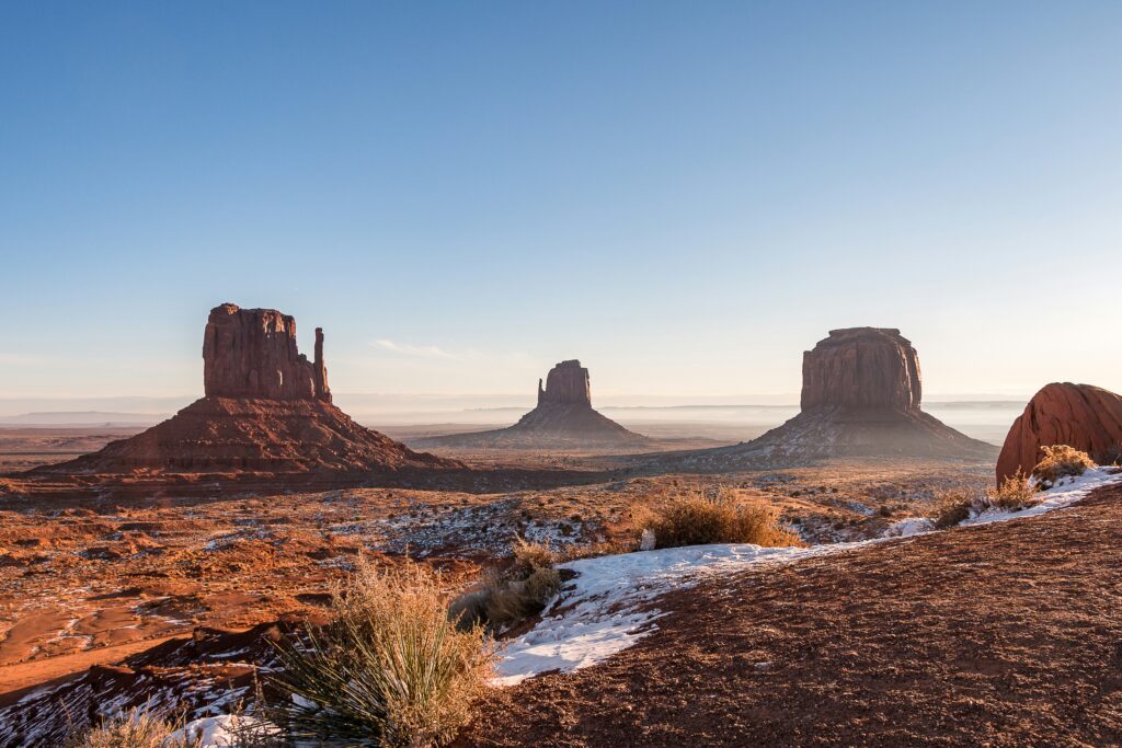 a desert landscape with snow and rocks