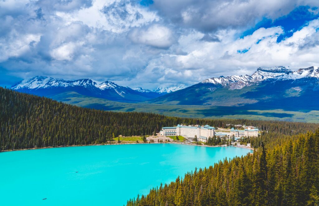 a blue lake surrounded by trees and mountains