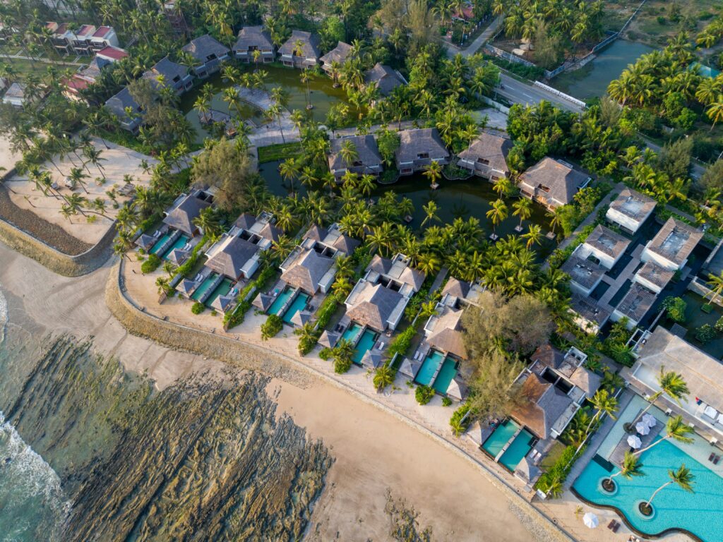a aerial view of a resort with swimming pools and trees