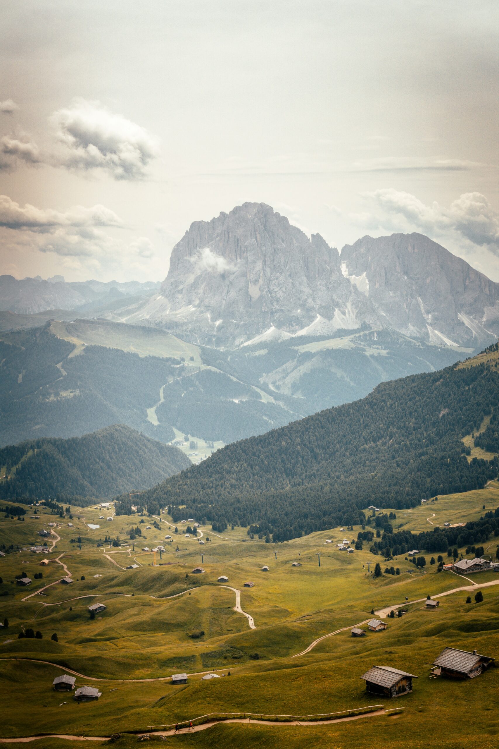 a landscape of a valley with mountains and a small village