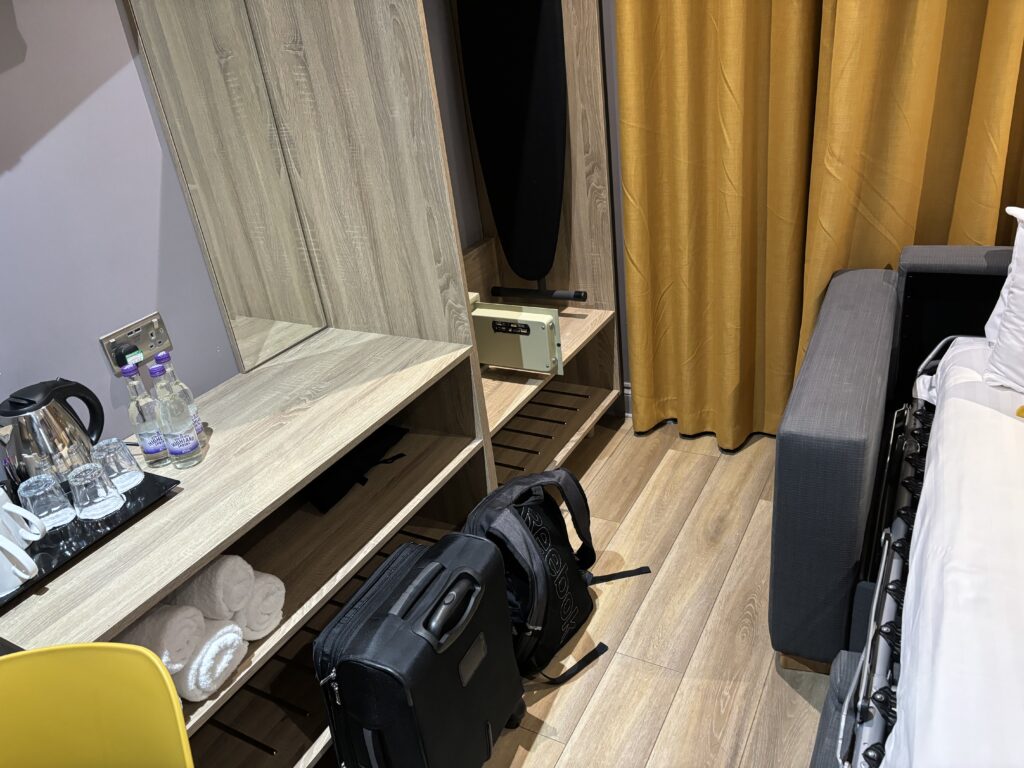 a room with a mirror and luggage