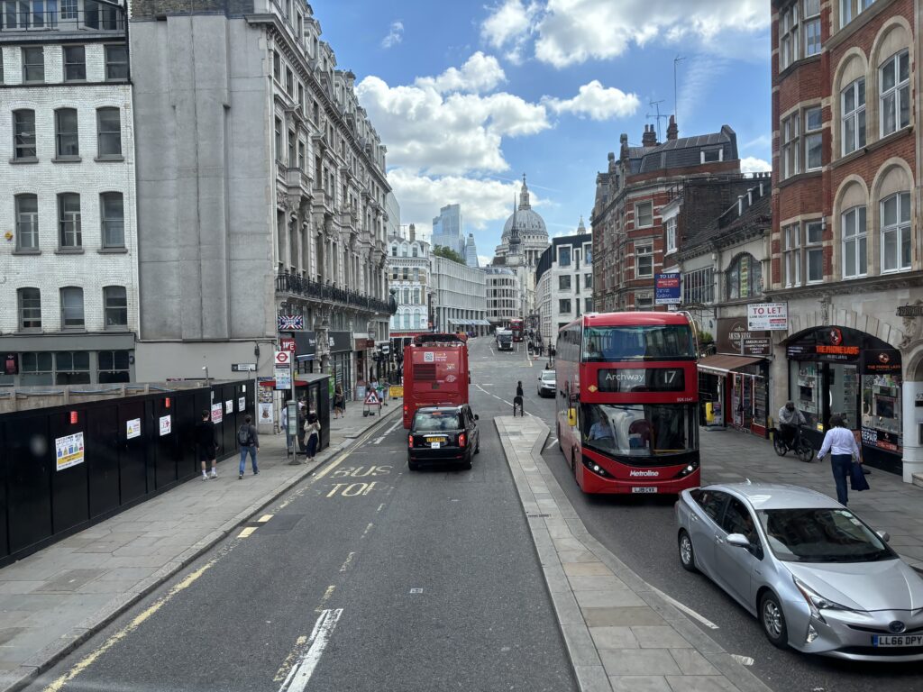 a double decker bus and a car on a street