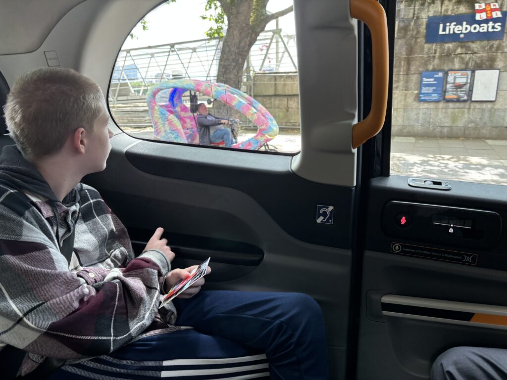 a boy sitting in a car looking out the window
