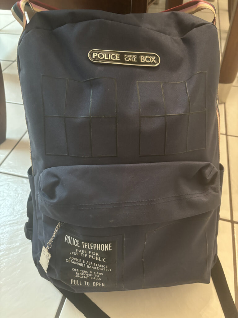 a black backpack with a police phone box on it
