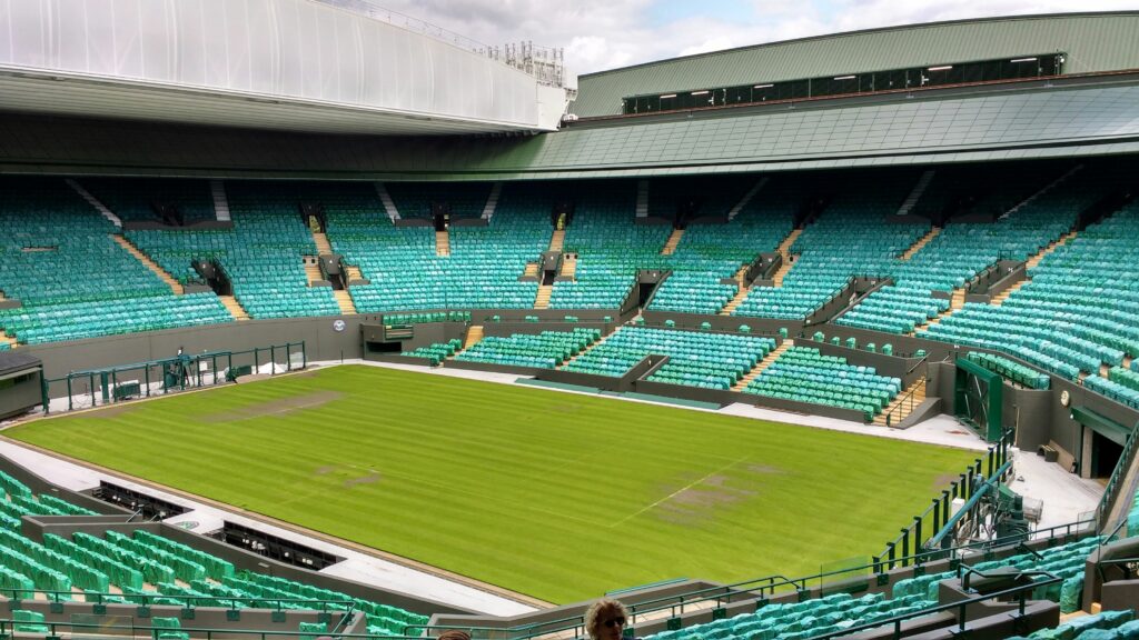 a tennis court with green seats
