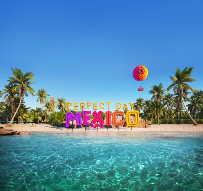 a beach with palm trees and a hot air balloon over it
