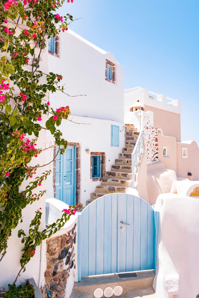 a white building with blue doors and stairs
