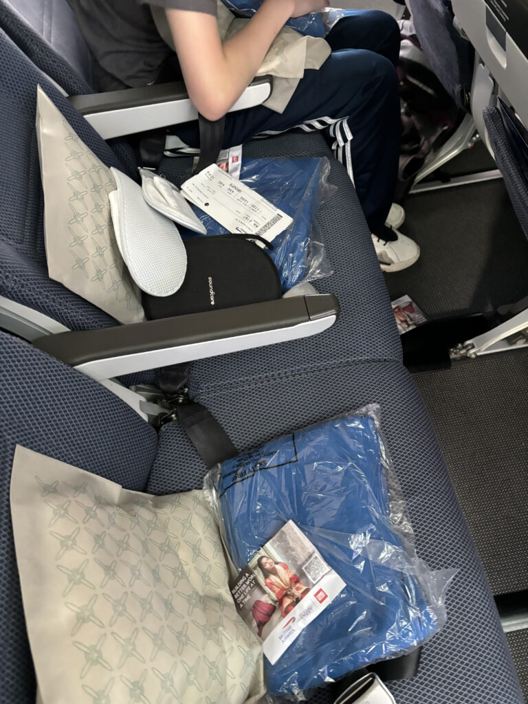 a person sitting in a chair with a bag of clothing