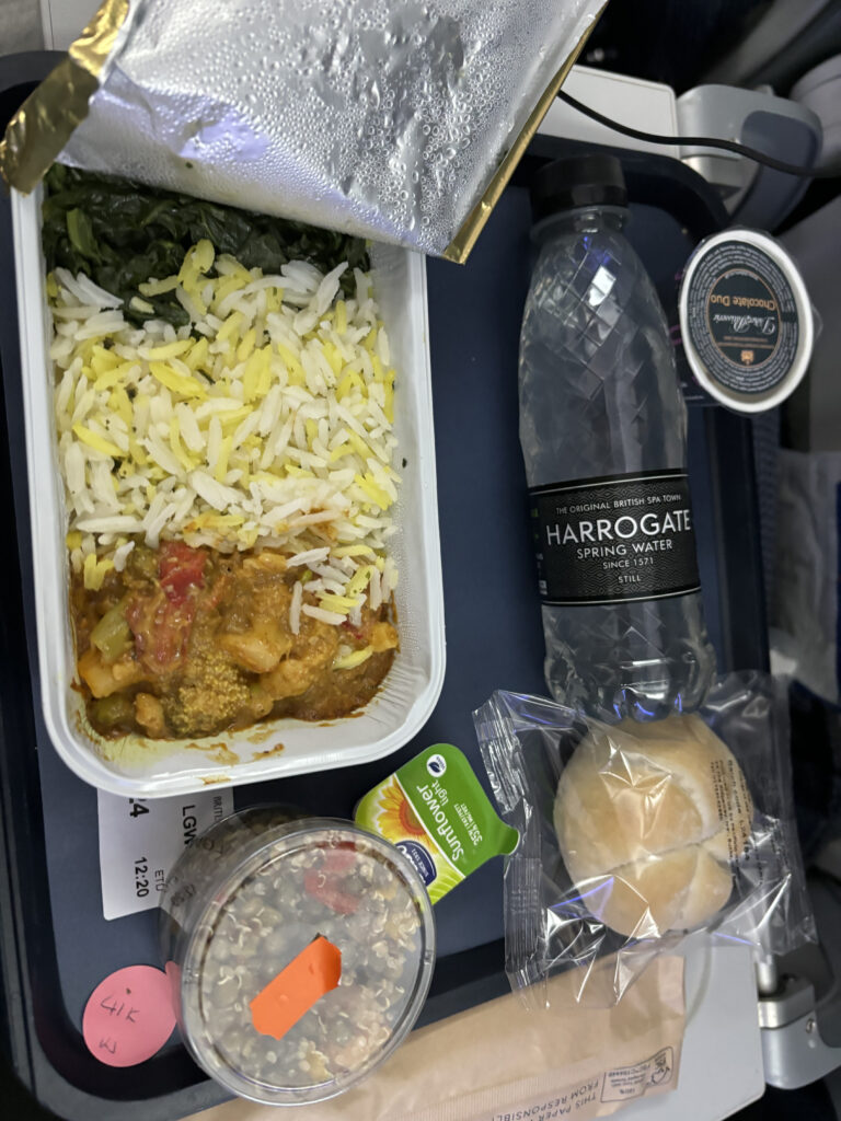 food on a tray with food and a bottle of water