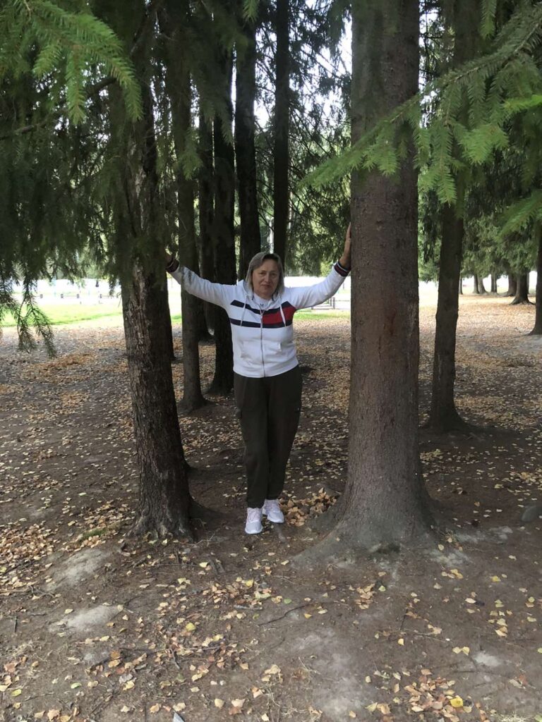 a woman standing in a forest