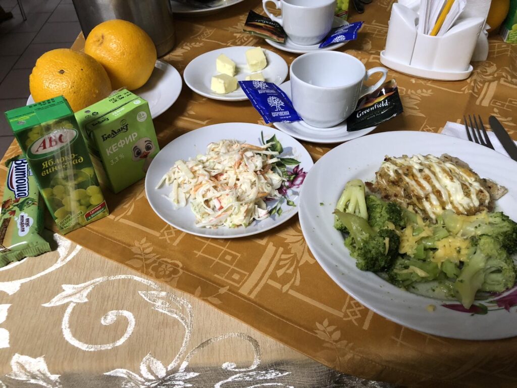 a table with plates of food and oranges