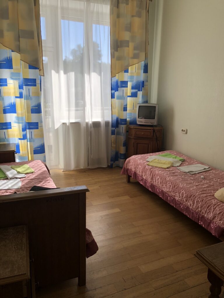 a room with two beds and a television