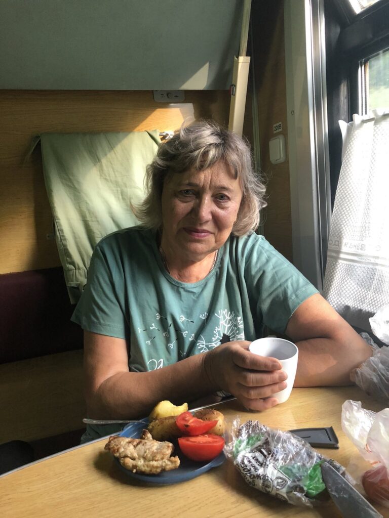 a woman sitting at a table with food