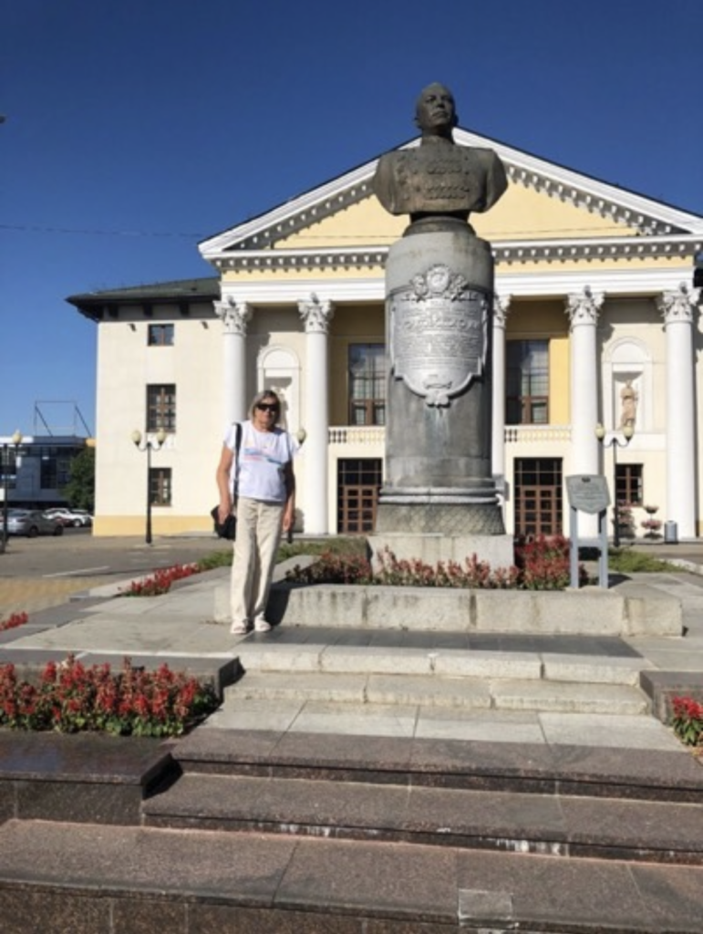 a man standing in front of a statue