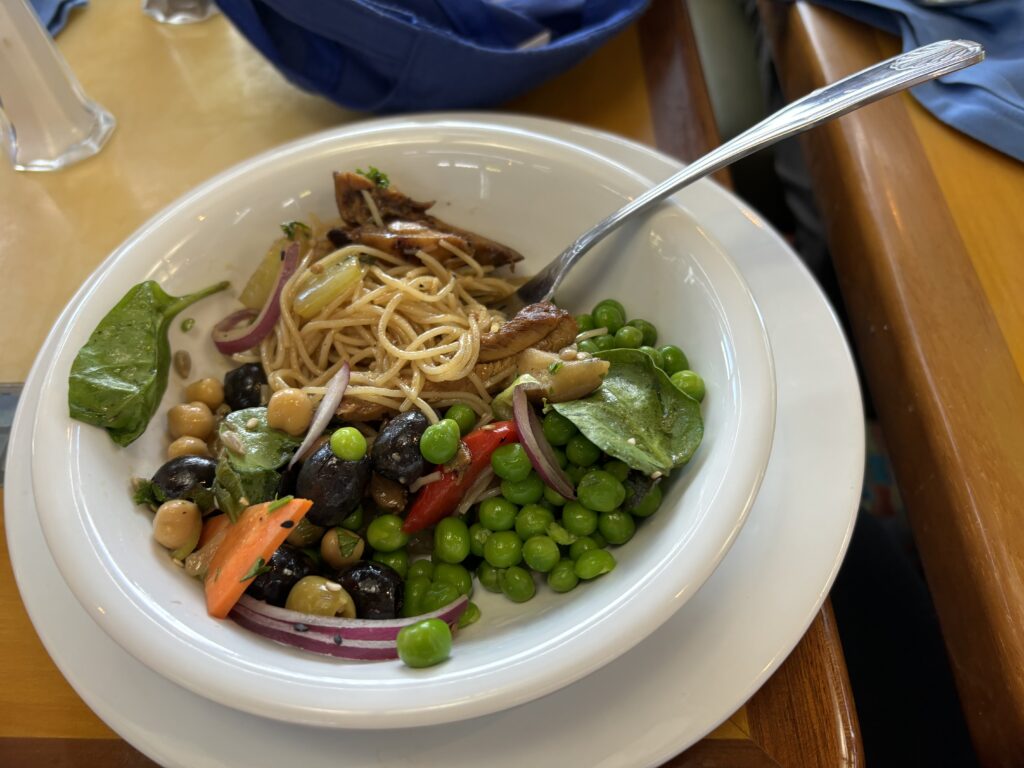 a bowl of pasta with vegetables and a fork