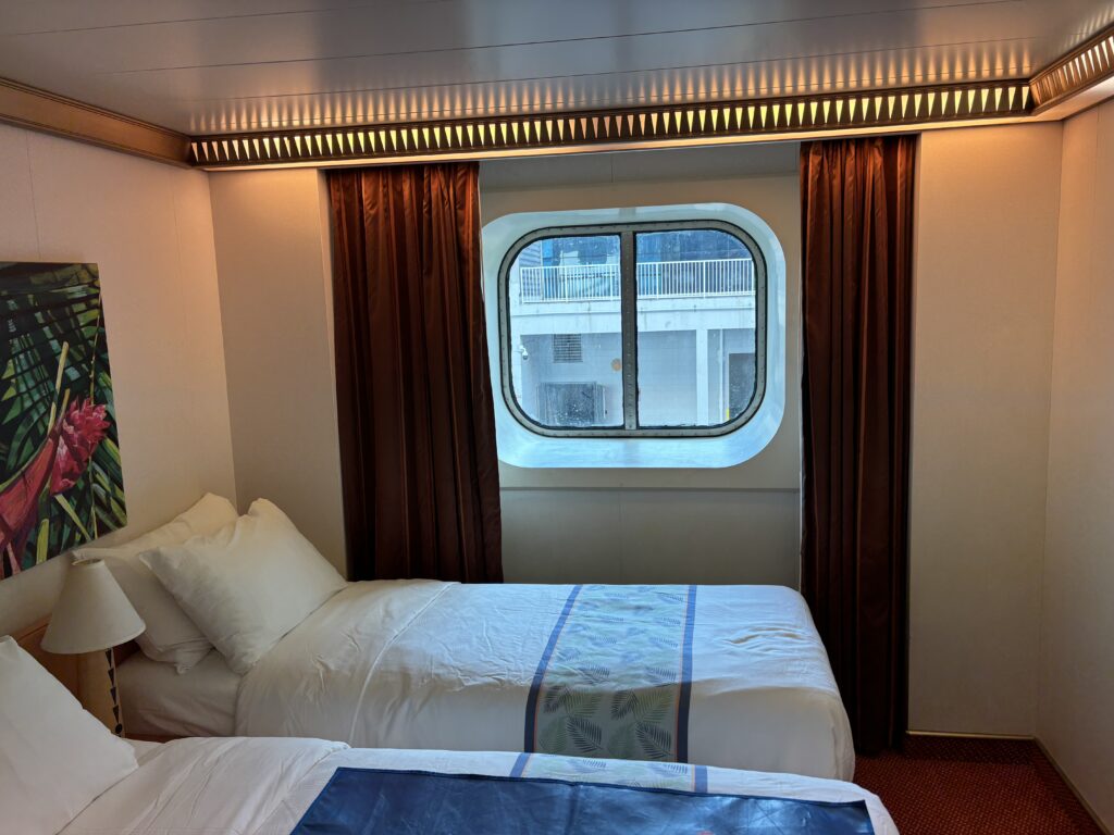 a two beds in a room with a window
