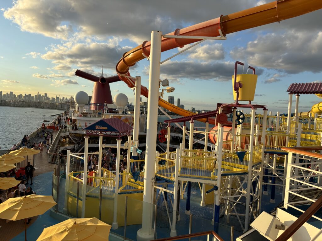 a water park with a water slide and a city in the background