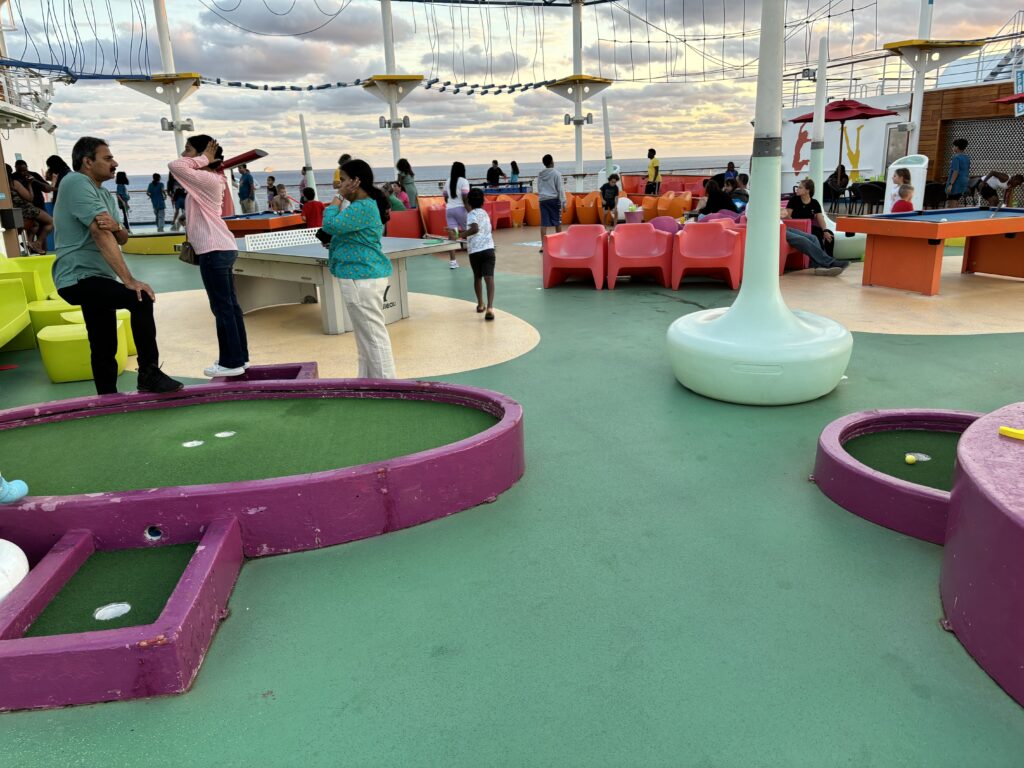 people on a deck with a miniature golf course