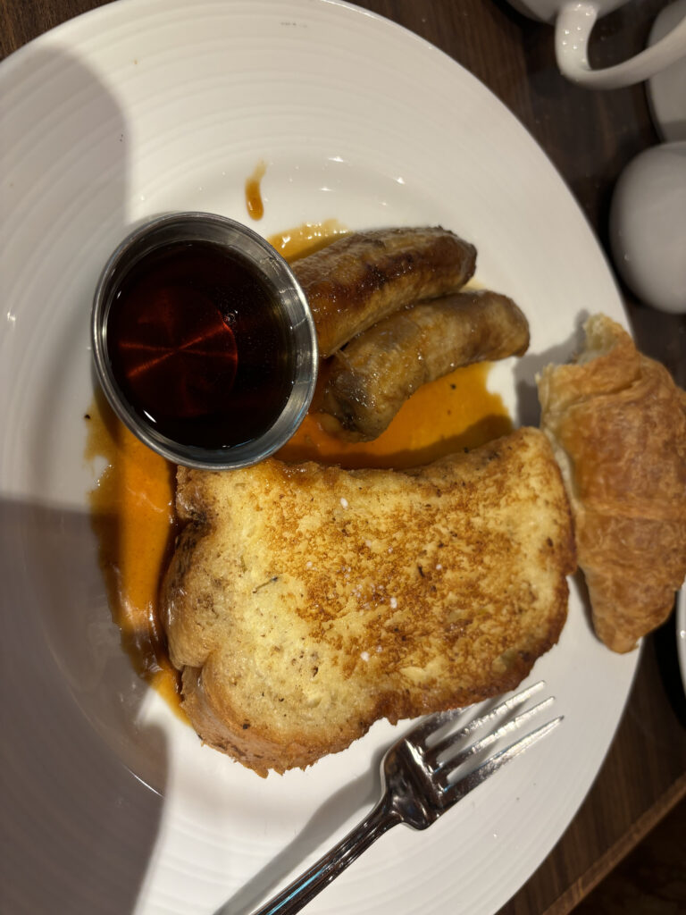 a plate of food with a fork and a small bowl of sauce