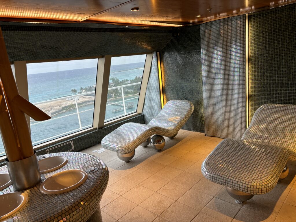 a room with mosaic chairs and a large window