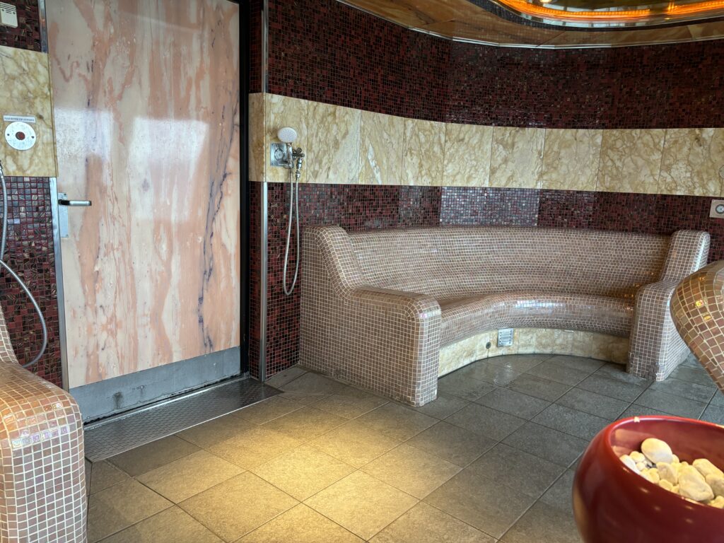 a tiled room with a curved bench
