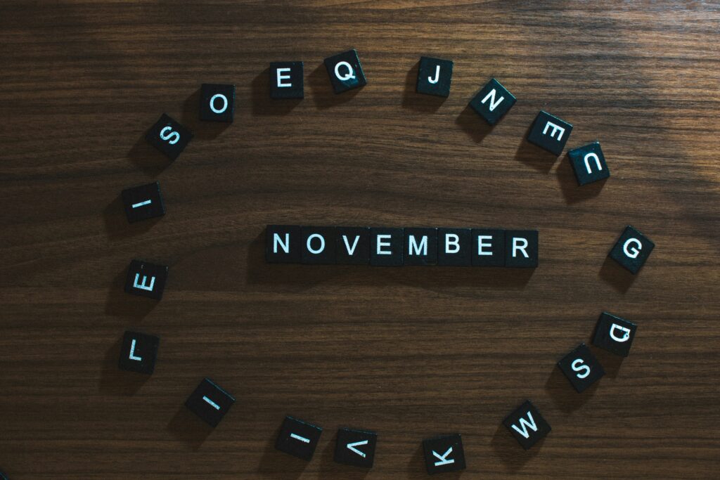 a group of black square letters on a wood surface