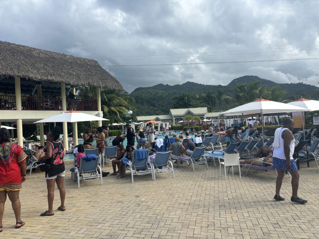 a group of people sitting in chairs and umbrellas