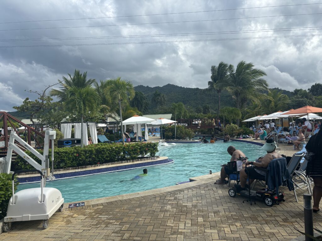 people sitting in a wheelchairs next to a pool