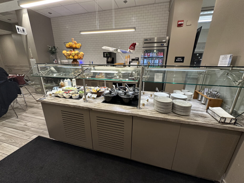 a buffet with plates and bowls on it
