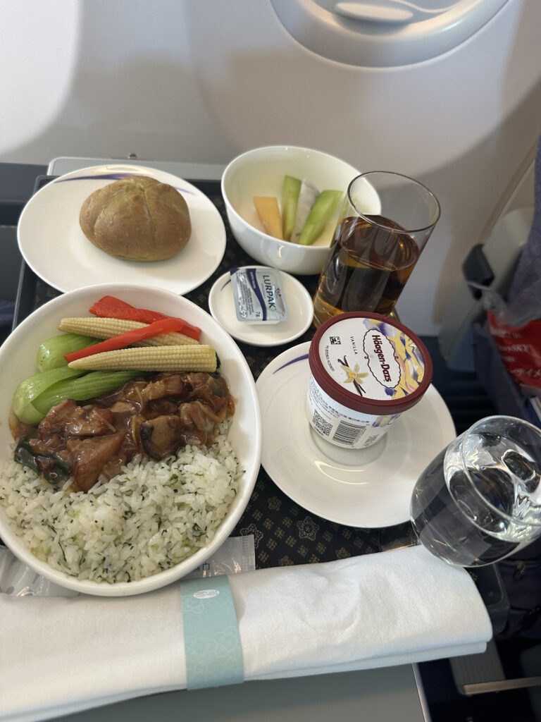 a plate of food and a glass of water on a tray