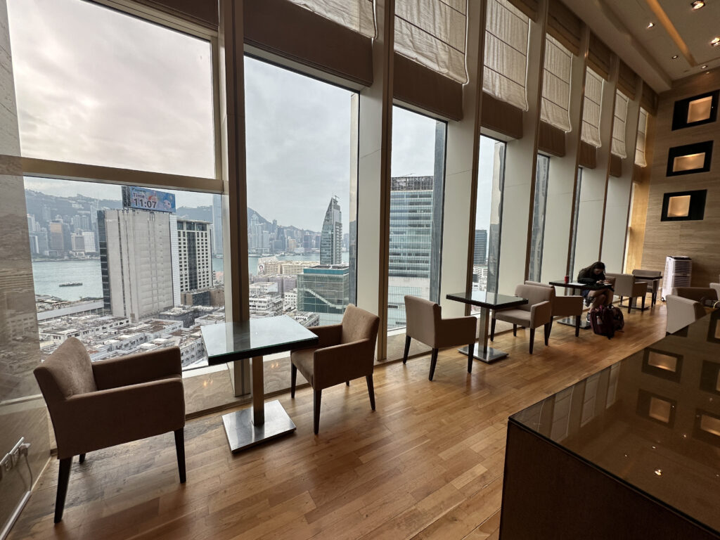 a room with tables and chairs and a large window