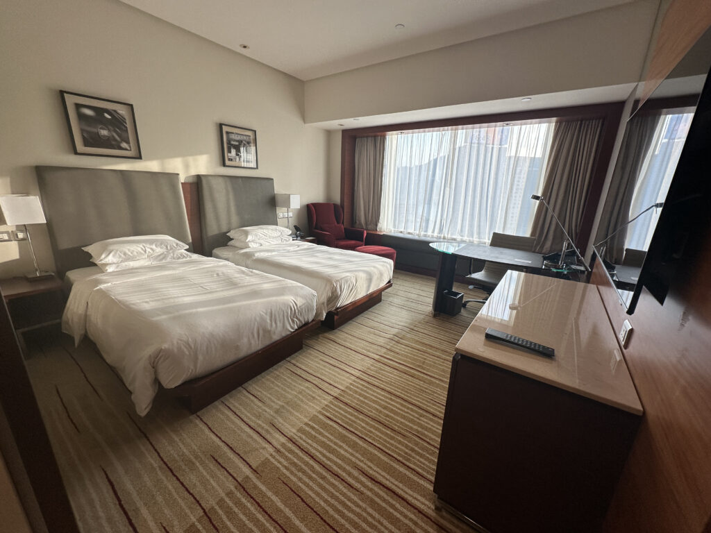 a room with two beds and a desk