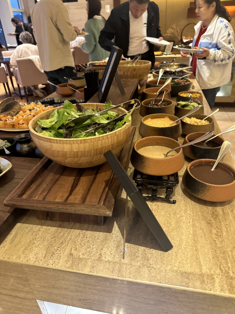 a buffet table with bowls of food