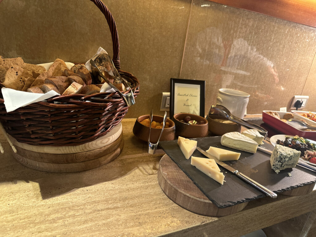 a basket of cheese and bread on a table