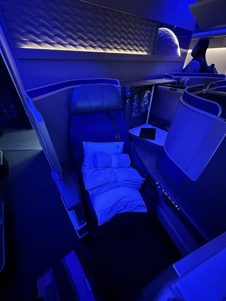 a seat with blankets and blankets on it