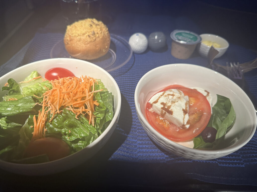 a salad and tomato in bowls