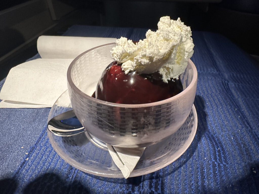 a glass cup with a dessert on it