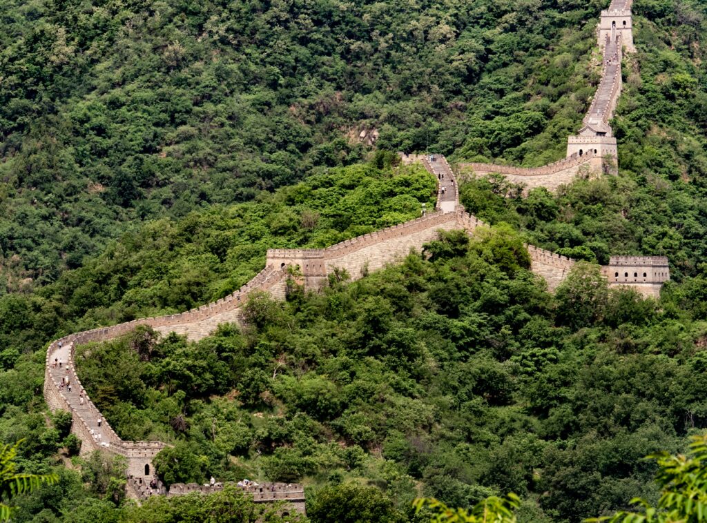 a large stone wall with trees around it