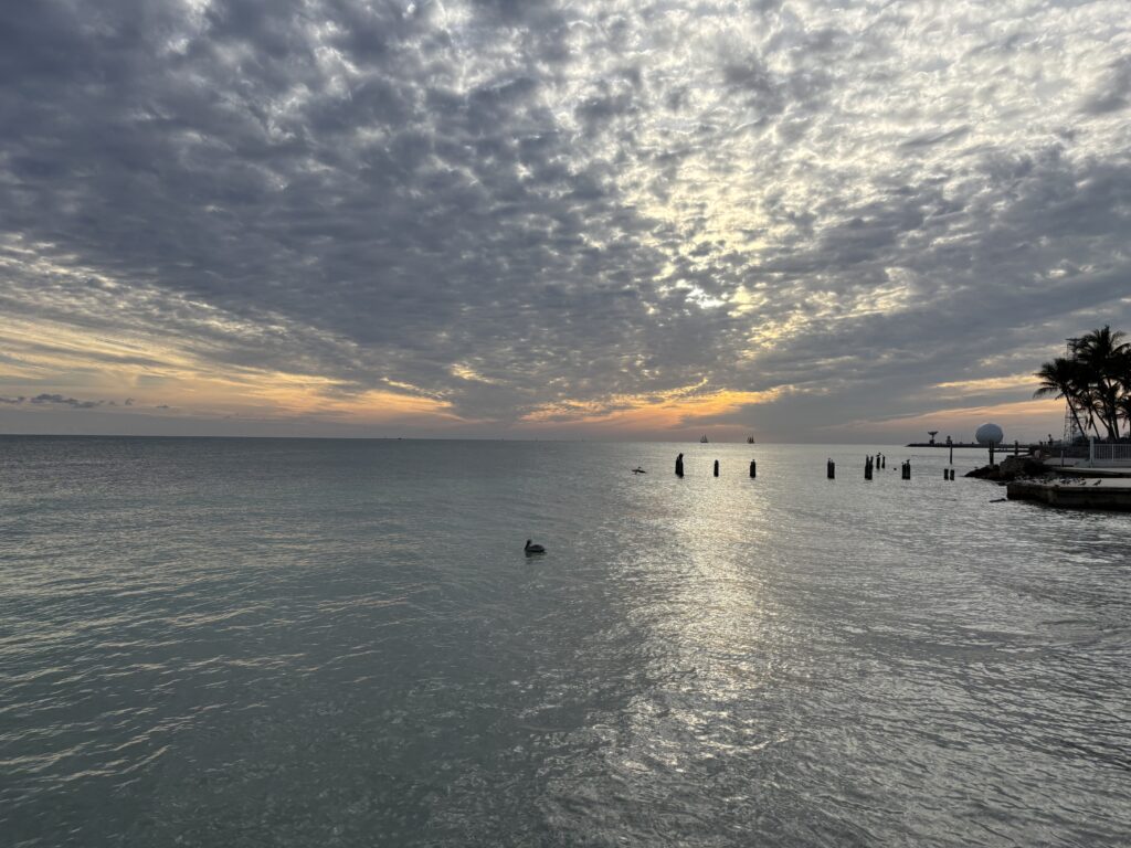 a body of water with a cloudy sky