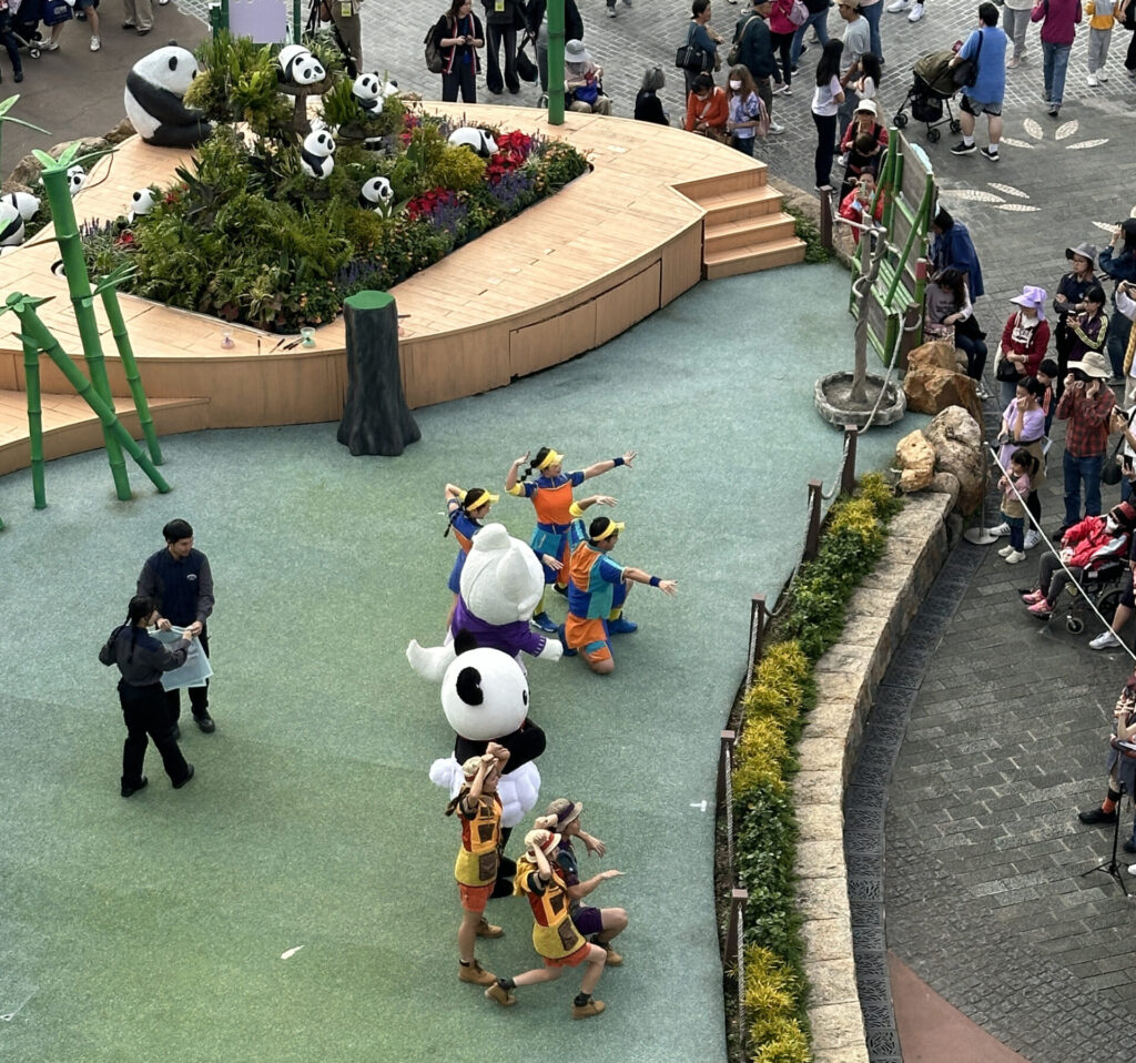 people in garmentd characters in a park