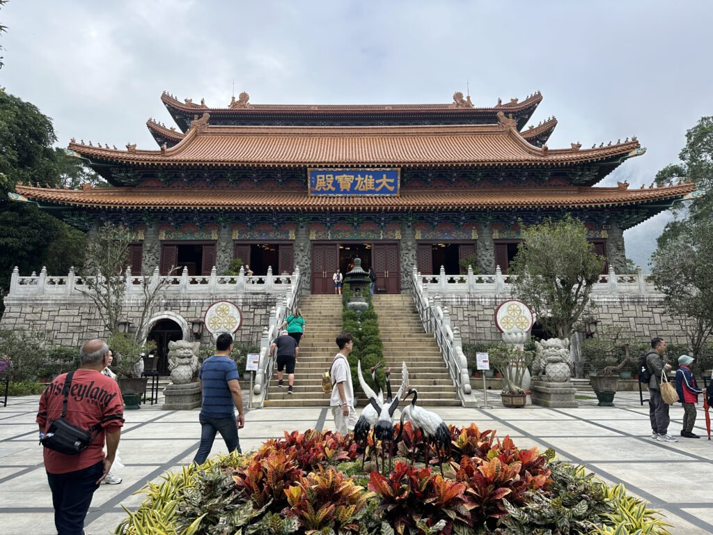 a building with a large roof and stairs leading to it