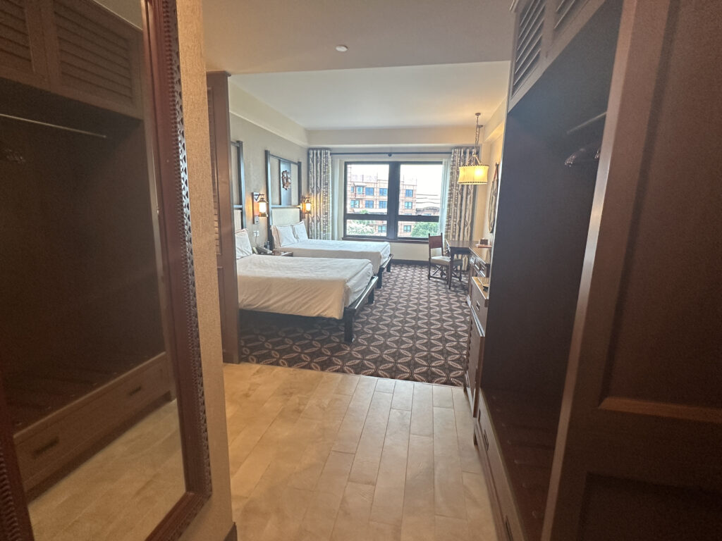 a room with two beds and a mirror