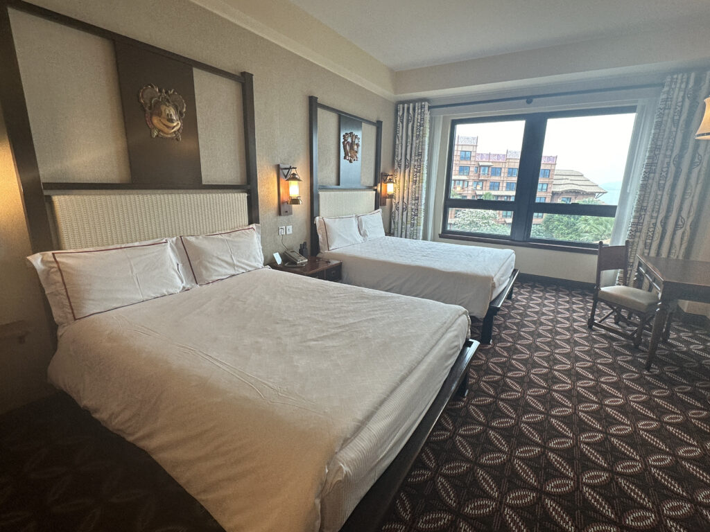 a room with two beds and a chair
